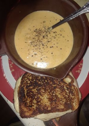 A picture of Cheese Bacon Broccoli Soup with Grilled Turkey Muenster Sandwich.