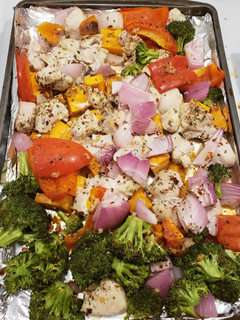 A picture of 1 pan chicken with sweet potatoes & veggies.