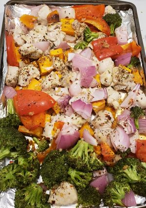 A picture of 1 pan chicken with sweet potatoes & veggies.
