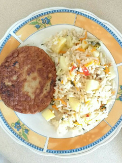 Una foto de Arroz con papas y hamburguesa de carne vegetal