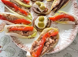 Una foto de Endivias de atún con pimientos y chasca con anchoas con tomate, queso de cabra y aceitunas