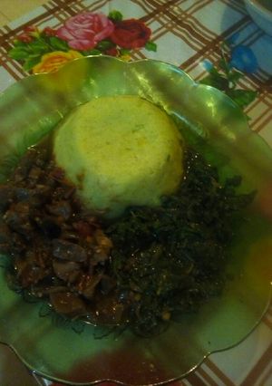 A picture of Mashed potatoes, liver n fried vegs.