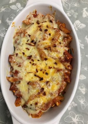 A picture of Pasta bake with kebab and egg.