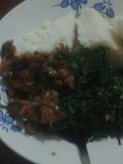 A picture of Ugali with beef and sukuma wiki.