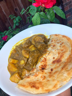 A picture of Caribbean Curry Goat with Roti.