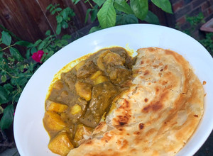A picture of Caribbean Curry Goat with Roti.