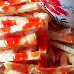 A picture of Fried yam and ketchup.