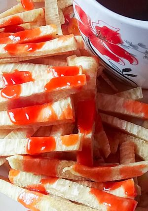 A picture of Fried yam and ketchup.
