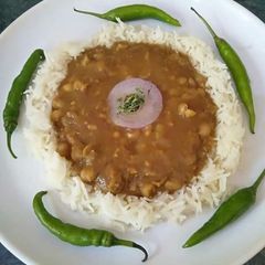 A picture of Tasty chana chawal with green chilli.