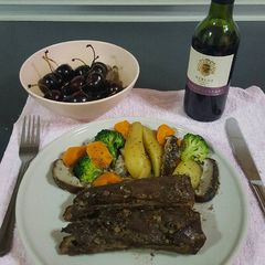 A picture of Pork ribs in red wine and honey sauce.