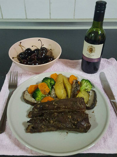 A picture of Pork ribs in red wine and honey sauce.