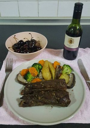 A picture of Pork ribs in red wine and honey sauce.