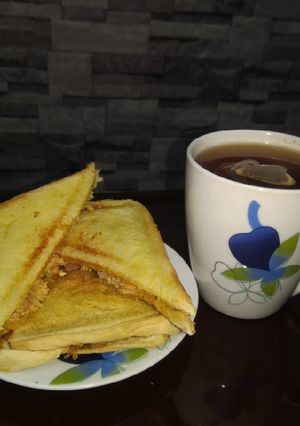 A picture of Scrambled egg toast and tea.