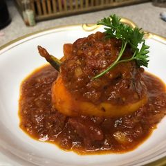 A picture of Stuffed Bell Peppers with Tomato Sauce.