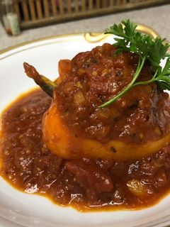 A picture of Stuffed Bell Peppers with Tomato Sauce.