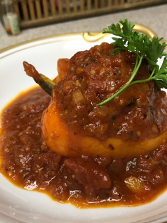 A picture of Stuffed Bell Peppers with Tomato Sauce.