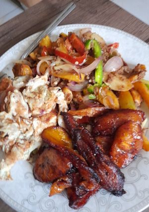 A picture of Potato beef stir fry, fried plantain with scrambled eggs.