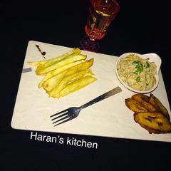 A picture of Fried sweet potatoes with plantain and scrambled eggs.