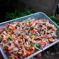 A picture of Assorted chicken and veggies noodles.