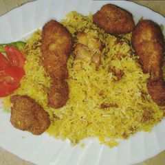 A picture of Chicken Tikka biryani & crispy chicken pieces.