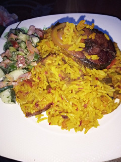 A picture of Palm oil Jealof rice With salad.
