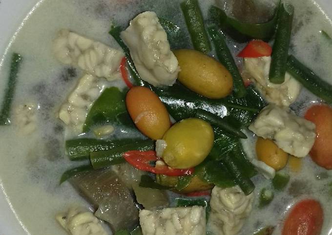 Bowl of sayur lodeh with assorted vegetables in coconut milk curry