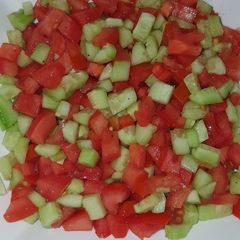 A picture of Tomatoes cucumber salad.