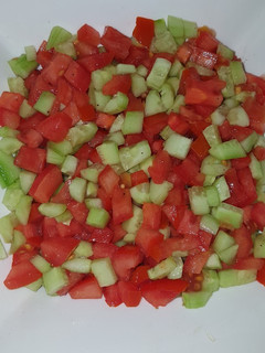 A picture of Tomatoes cucumber salad.