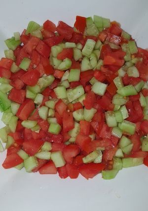 A picture of Tomatoes cucumber salad.