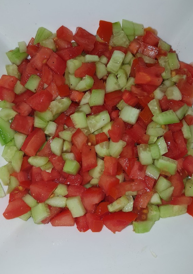 A picture of Tomatoes cucumber salad.