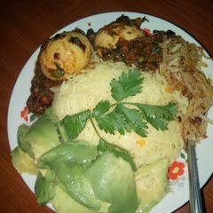 A picture of Egg curry with tumeric rice.