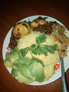 A picture of Egg curry with tumeric rice.