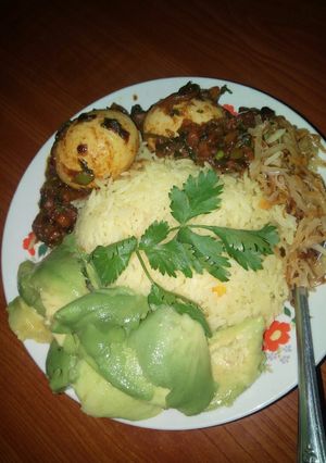 A picture of Egg curry with tumeric rice.