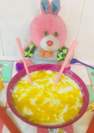 A picture of Porridge with mangoes purée.