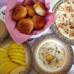 A picture of Paratha, Full fry Egg, sliced Apple, garlic herb mini buns.