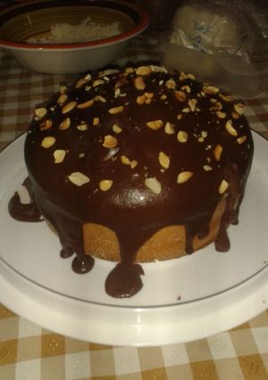 Una foto de Torta tipo ponque cubierta en chocolate y maní