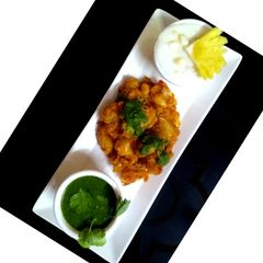 Potato chaat with pineapple Raita & Mint Chutney A picture of Potato chaat with pineapple Raita & Mint Chutney.