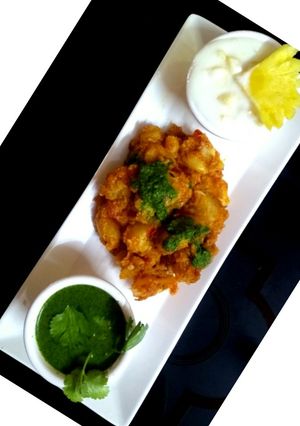 A picture of Potato chaat with pineapple Raita & Mint Chutney.