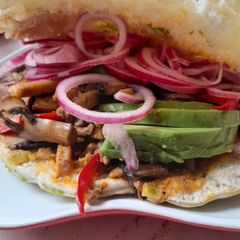 A picture of Pita bread with pork and avocado.