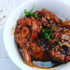 A picture of Pork shank in red wine and balsamic sauce.