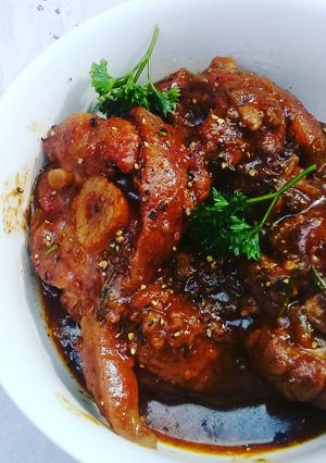 A picture of Pork shank in red wine and balsamic sauce.