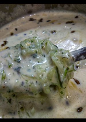 A picture of Curd with cucumber.