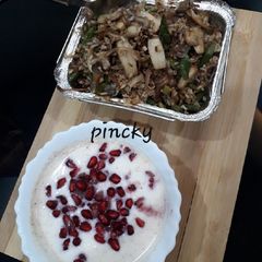 A picture of Mushroom pulav with dahi raita.