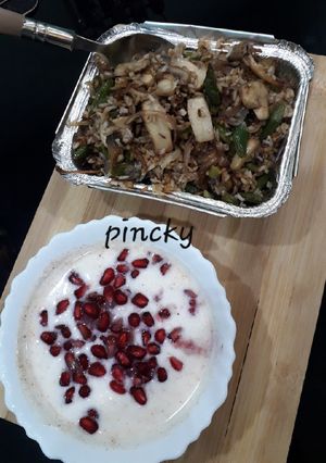 A picture of Mushroom pulav with dahi raita.