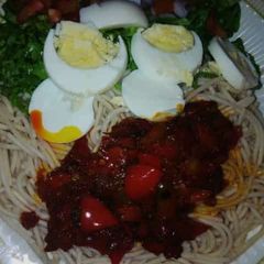 A picture of Taliya + stew with salad and eggs.