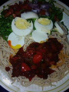 A picture of Taliya + stew with salad and eggs.