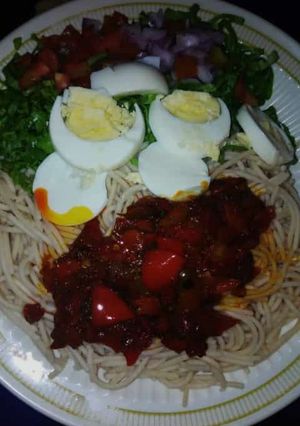 A picture of Taliya + stew with salad and eggs.