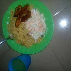 A picture of Fried rice and plantain with cucumber and ginger drink.