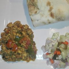 A picture of Chicken Qeema Tomato and Green Bell Pepper with chacumar Salad.