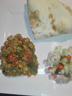 A picture of Chicken Qeema Tomato and Green Bell Pepper with chacumar Salad.